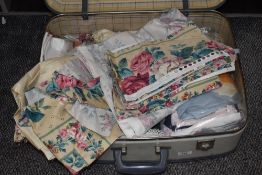 A suitcase containing a variety of fabric, including retro Hardy Fabrics 'Rosedale Stripe'.