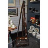 A 19th/20th Century stained wood tripod stand, 156cm tall, a vintage spirit level, and a cased Dumpy