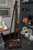 A 19th/20th Century stained wood tripod stand, 156cm tall, a vintage spirit level, and a cased Dumpy