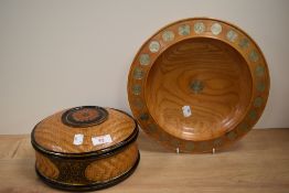 A Japanese lacquered and bamboo lidded basket, mid-20th Century, and a treen five pence bowl,