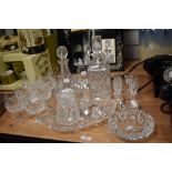 An assorted collection of cut glassware, to include decanters, brandy balloons, and a dressing table