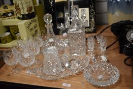 An assorted collection of cut glassware, to include decanters, brandy balloons, and a dressing table