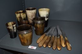 An assorted collection of horn beakers and horn handled Virole Argent knives