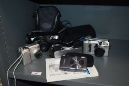 A selection of cameras, including Minolta Dimage S414 and Nikon Coolpix 775.