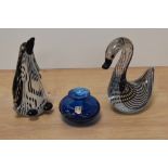 Two vintage paperweights, one a duck and the other a penguin both having striped inclusions, also