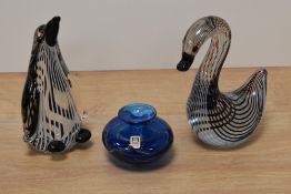 Two vintage paperweights, one a duck and the other a penguin both having striped inclusions, also