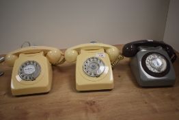 Three vintage bakelite telephones in cream and grey