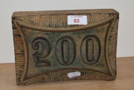 A vintage wooden printing block, '200', stamped 'O.Holmes, Manchester', 14cm x 29cm overall