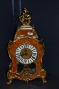 A late 20th century Italian mantel clock, having burr walnut effect case with brass foliate accents,