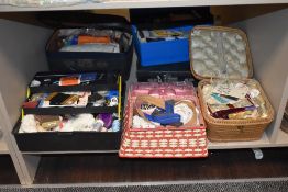An assortment of haberdashery, including vintage sewing boxes, zips, thread, needles, fastenings