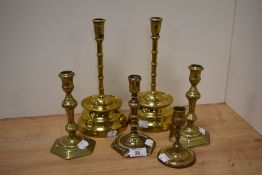 A collection of 19th and early 20th century brass candlesticks.