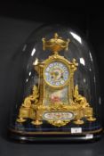 A 19th century French ornate ormolu mantel clock, having highly decorative porcelain inserts, with