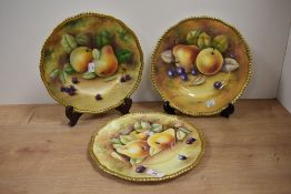 Three hand painted Coalport plates, signed by R Dale, A Baggott and Joseph Motram.