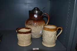 A 19th Century salt glazed lidded jug, in the Doulton Lambeth style, having a silver hallmarked lid,