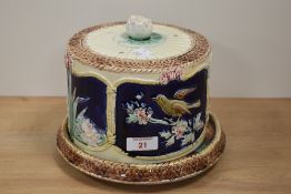 A 19th century Majolica cheese dome, having bird and flower decoration to sides, AF.