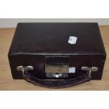 An early 20th century aubergine coloured travel jewellery case, having purple silk lining and