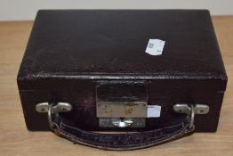 An early 20th century aubergine coloured travel jewellery case, having purple silk lining and