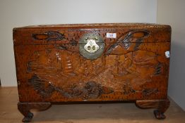 A carved camphor wood chest, of smaller proportions, having ship and ocean scene and engraved