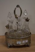 A Victorian silver plated cruet stand containing a set of six cut glass cruets, 28cm tall