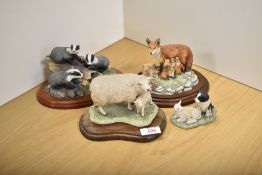 A group of four Border Fine Arts animal groups, comprising 'Fox Family' RW25 from the Chiltern