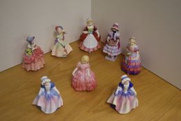 A group of eight small Royal Doulton bone china figurines, comprising 'Babie' HN1674, 'Valerie'