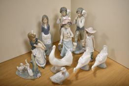 A group of Nao porcelain figures, figurines and bird ornaments, each styled in the traditional