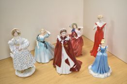 A group of three Royal Worcester fine bone china figurines, comprising HM Queen Elizabeth II,