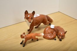 A group of three Beswick Pottery Fox studies, comprising Fox standing, large 1016a, in red/brown and
