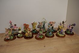 A group of thirteen 'Flower Fairies' figurines, produced by Enesco EEGG Limited and inspired by