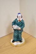 A Royal Doulton bone china clown figure 'Will He - Wont He?' HN 3275, modelled standing with