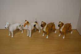 A Group of four Beswick Pottery Dog studies, comprising two Boxers 'Blue Mountain Greta' 1202, in
