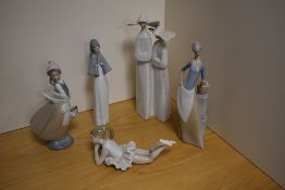 A Lladro porcelain figure group, depicting two young nuns, with wide brimmed hats, printed and