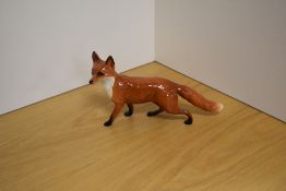 A Beswick Pottery study of a fox, standing 1016a, designed by Arthur Gredington in red/brown gloss