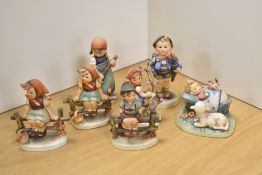 A group of seven Goebel porcelain 'Hummel' figures and figurines, to include 'The Guardian', '