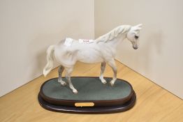 A Royal Doulton bone china horse study 'Desert Orchid' in matt grey with moulded wooden plinth