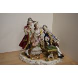 An early 20th century Rudolstadt-Volkstedt porcelain figural tableau group, formed as a group of