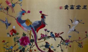 A 20th Century Chinese silk embroidery, of rectangular form, depicting exotic birds on flowering br