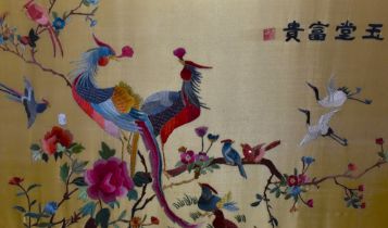 A 20th Century Chinese silk embroidery, of rectangular form, depicting exotic birds on flowering br