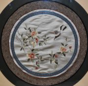 A 20th Century Chinese silk embroidery, of circular form, depicting a bird beside flowering branche