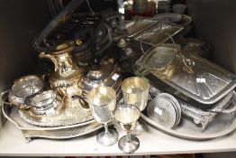 An assortment of flat ware and cutlery, including plated ware, serving dishes, goblets and