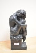 A modern bronze effect sculpture, stamped 'Austin Sculpture' to the base, and depicting a seated