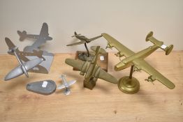 An assorted collection of metal ornamental planes on stands