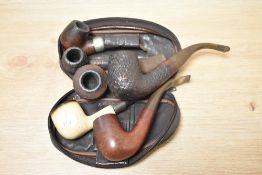 Six vintage tobacco pipes, including K & B Peterson.