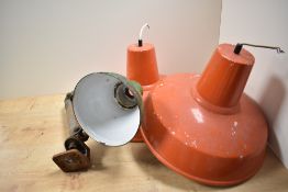A pair of mid-20th Century enamelled orange industrial light shades, and an angle poise lamp of
