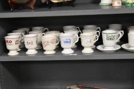 An assorted collection of early 20th Century Oxo and Bovril advertising cups, some with saucers