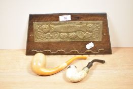 A 1930s wall mounted pipe rack having embossed decoration and reading 'Smoke and be happy', sold