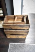 A collection of vintage pine advertising crates