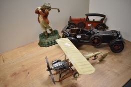 Two mid-late 20th Century cast iron door stops, in the form of a golfer and a Model T car, plus