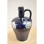 An Art Noveau bottle vase, having dark blue ground with thistle decoration, marked to underside