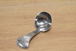 A Keswick school of industrial arts hammered stainless steel caddy spoon.